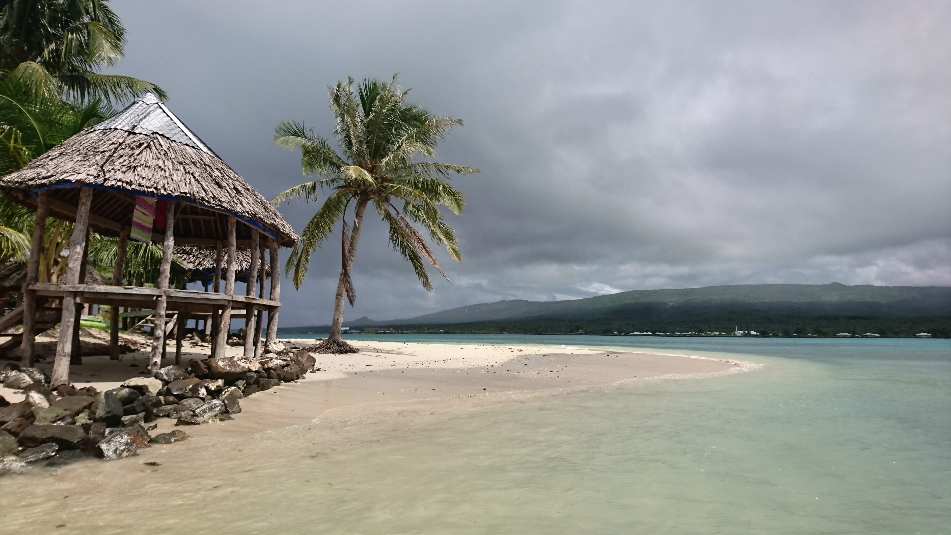 a widescreen stormy beach with a hut